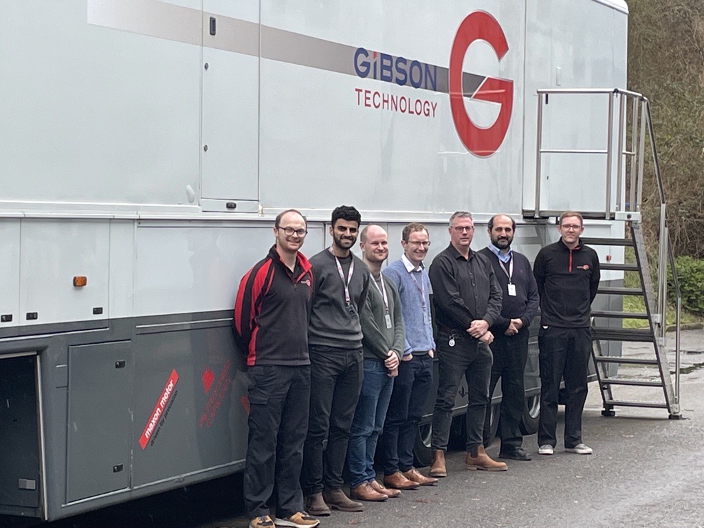 The Gibson Technology and Loughborough University AKT2I partnership team with GT’s vehicle transporter. (Left to right) Josh Fuller, Hamza Mughal, Matt Simpson, Nick Morris, Ian Lovett, Ramin Rahmani and Rhys Thomas (and Nader Dolatabadi not pictured).